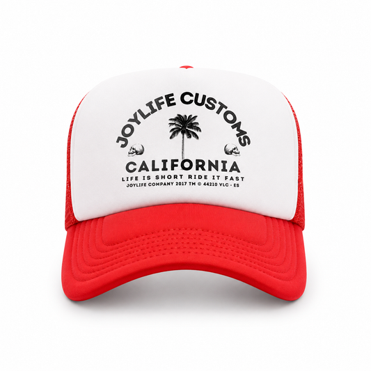 Angled view of white trucker cap with red visor and mesh panels