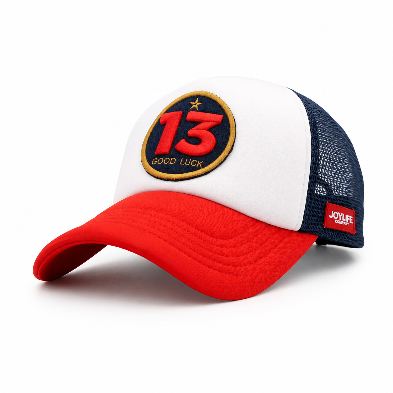 Angled view of white cap with red visor and navy mesh
